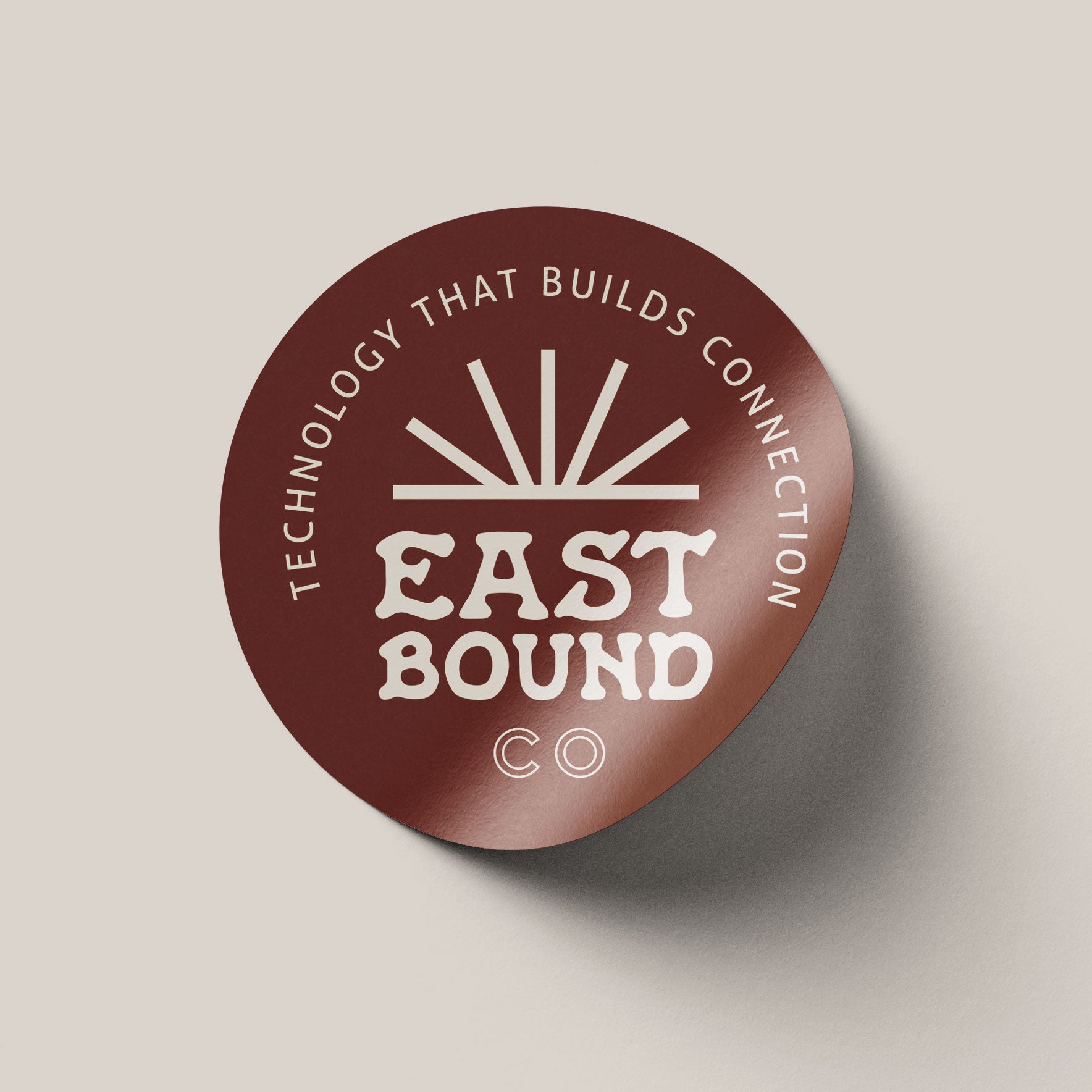 Round brown logo with 'EastBound Co' text on a beige background designed by O Hey Amy